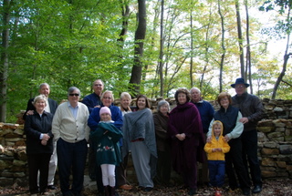 Full group photo by the wall